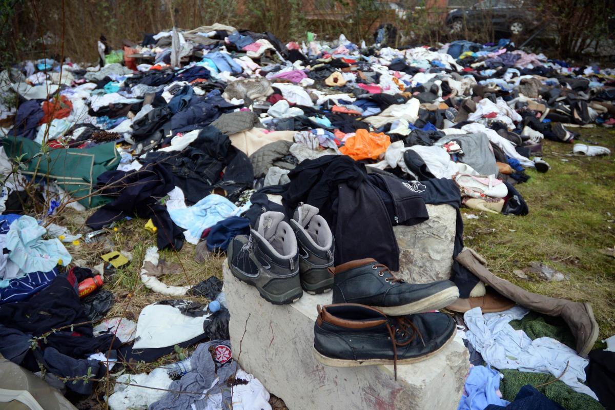 Piles of clothes and shoes dumped in Street